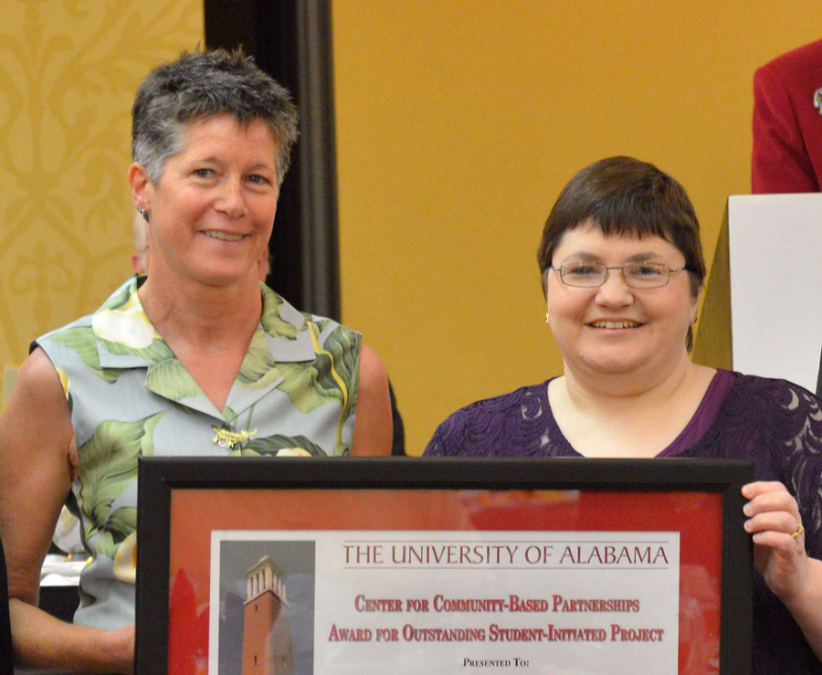 Jackie Brodsky holds her CCBP Award and smiles.