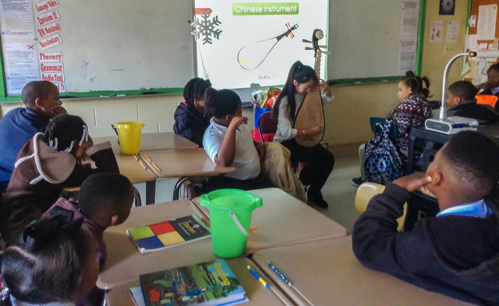 Heart Touch instructor plays traditional Chinese instrument known as pipa.