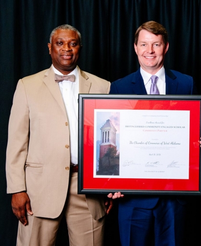 Jim Page of the Chamber of Commerce of West Alabama receives the Distinguished Community-Engaged Scholar Award–Community Partner. At left is Dr. Samory T. Pruitt.