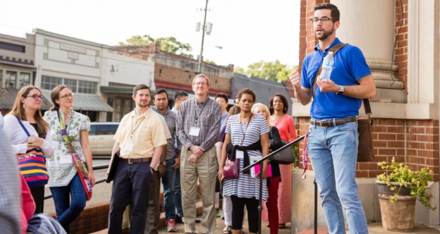 Tour group learns about the history of Marion from one of the panel members.
