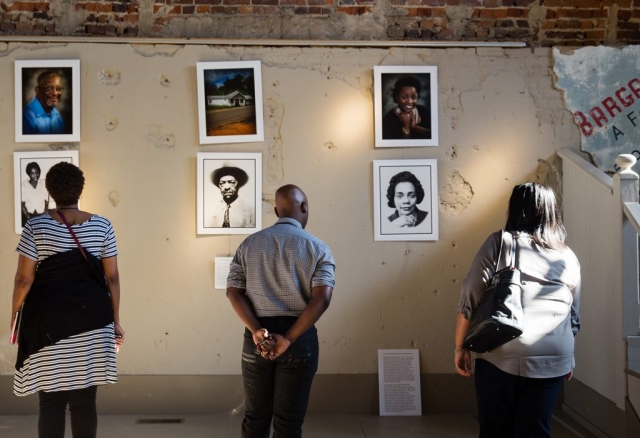 Viewers examine portraits of civil rights legends at the Smith Building Art Gallery in Marion, Alabama.