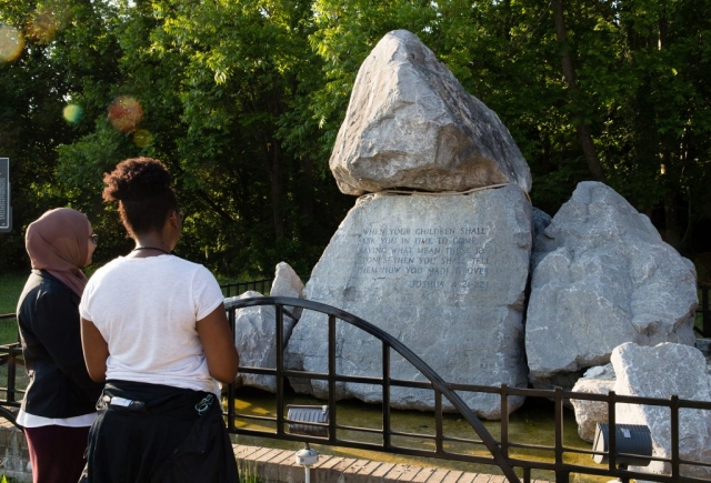 Tour participants view the rock sculpture located near the foot of the Edmund Pettus Bridge in Selma.