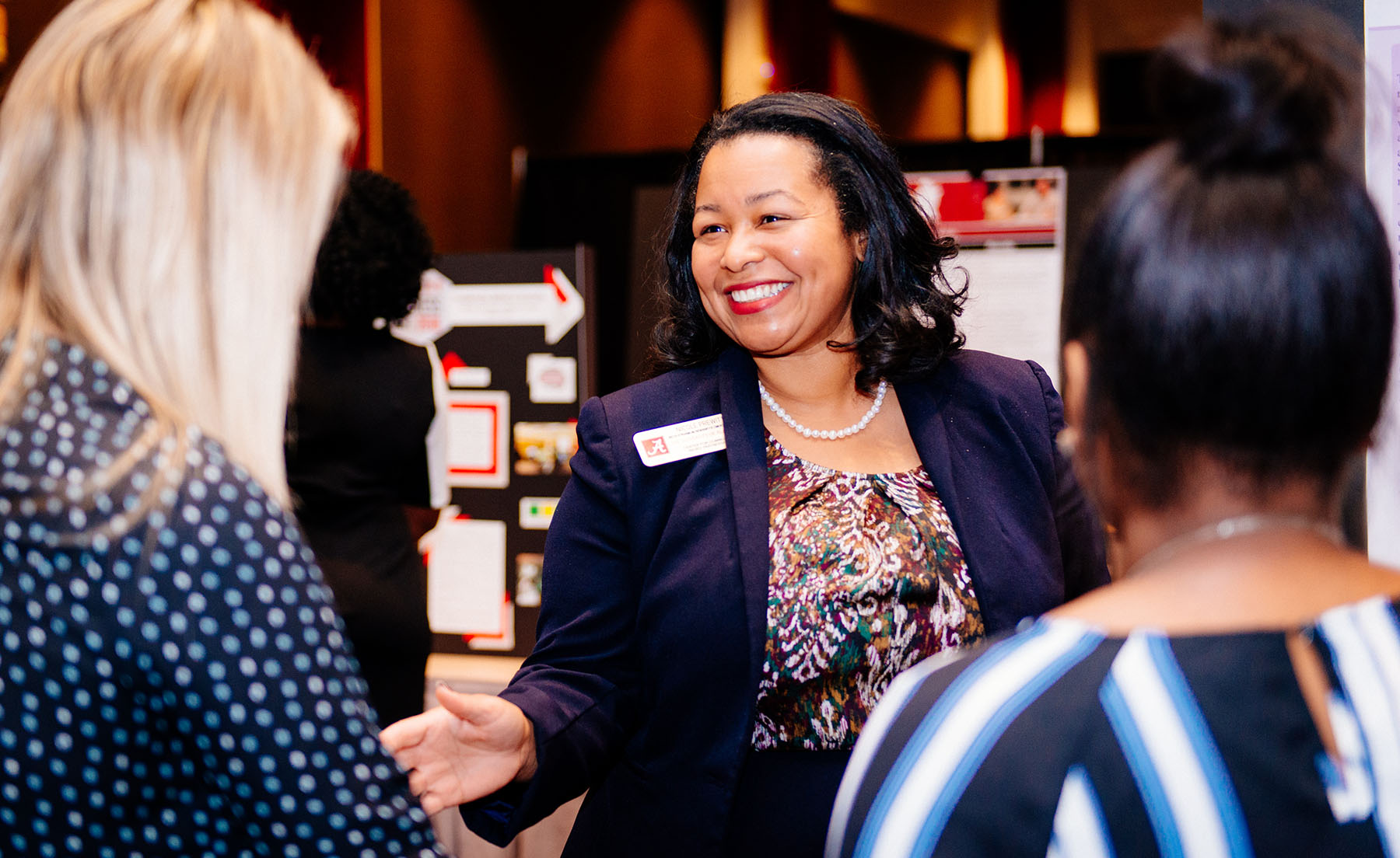 Dr. Nicole B. Prewitt and Awards Luncheon attendees admire the research posters at this year’s Awards Luncheon.