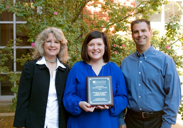 Dr. Elizabeth Wilson, Dr. Blake Berryhill, and Dr. Holly Morgan (center) are shown with the plaque recognizing UA’s Parent Teacher Leadership Academy as a recipient of the Partnership Organization Award from the National Network of Partnership Schools at Johns Hopkins University. Morgan is PTLA director and Wilson and Berryhill are faculty partners representing the Colleges of Education and Human Environmental Sciences.