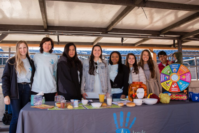 Morgan Renfroe, senior Public Health student (left) and Dr. Jen Nickelson, Faculty Advisor for Hands in Health (second from left), organized students to provide walkers with nutrition and exercise information.