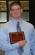 Image of Zach Dodson holding award plaque