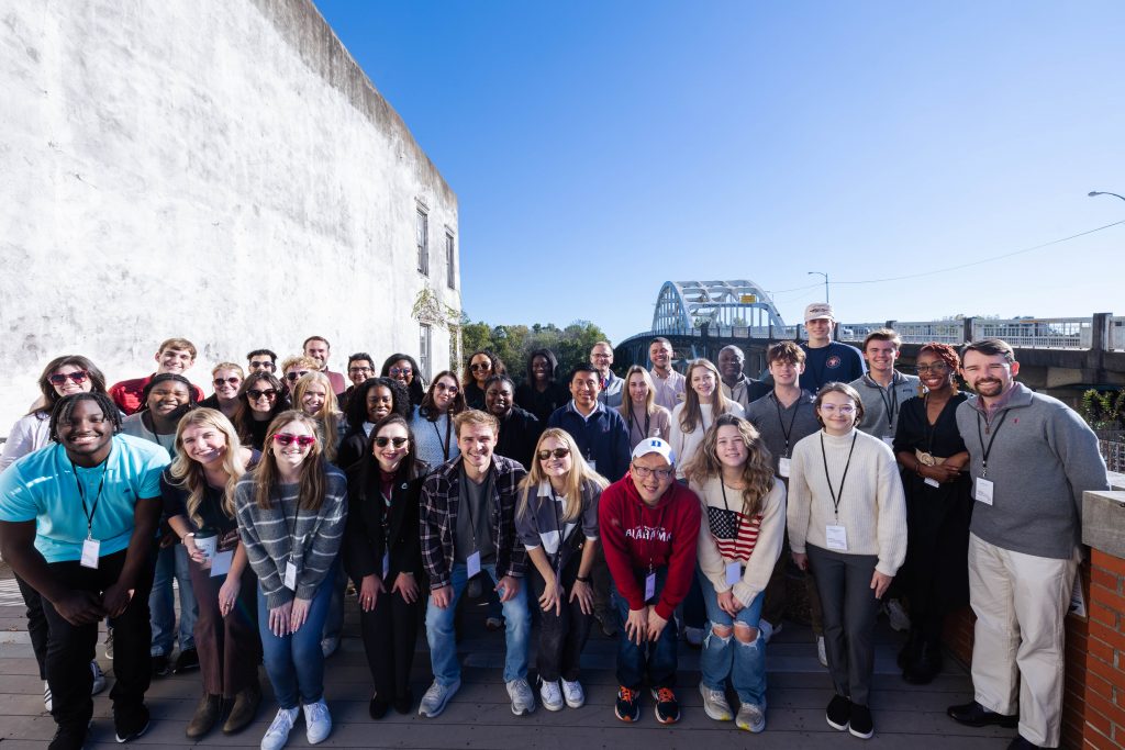 SCOPE students gather in front of the Edmund Pettus Bridge in Selma, Alabama, for a group picture during the Fall 2024 Student Community Engagement Tour to Selma.