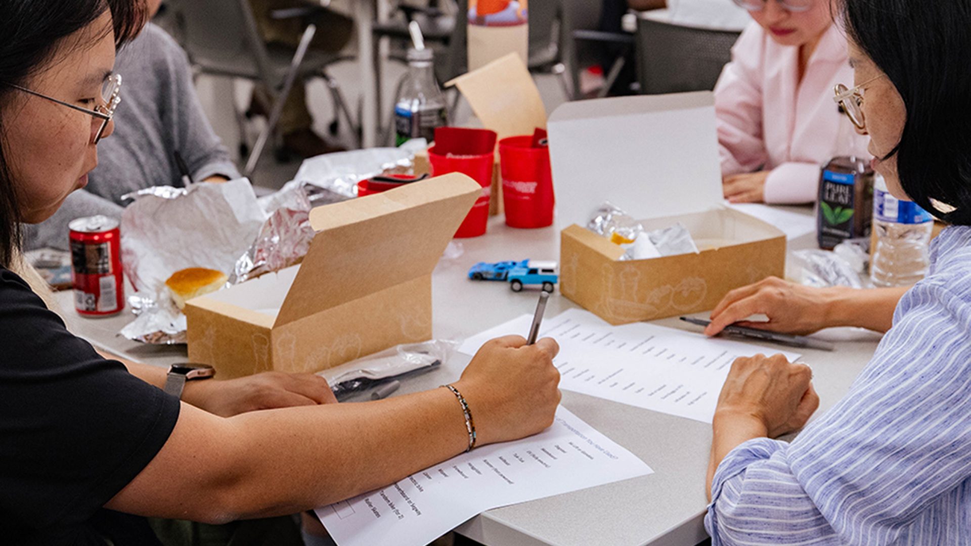 Someone writing at a table