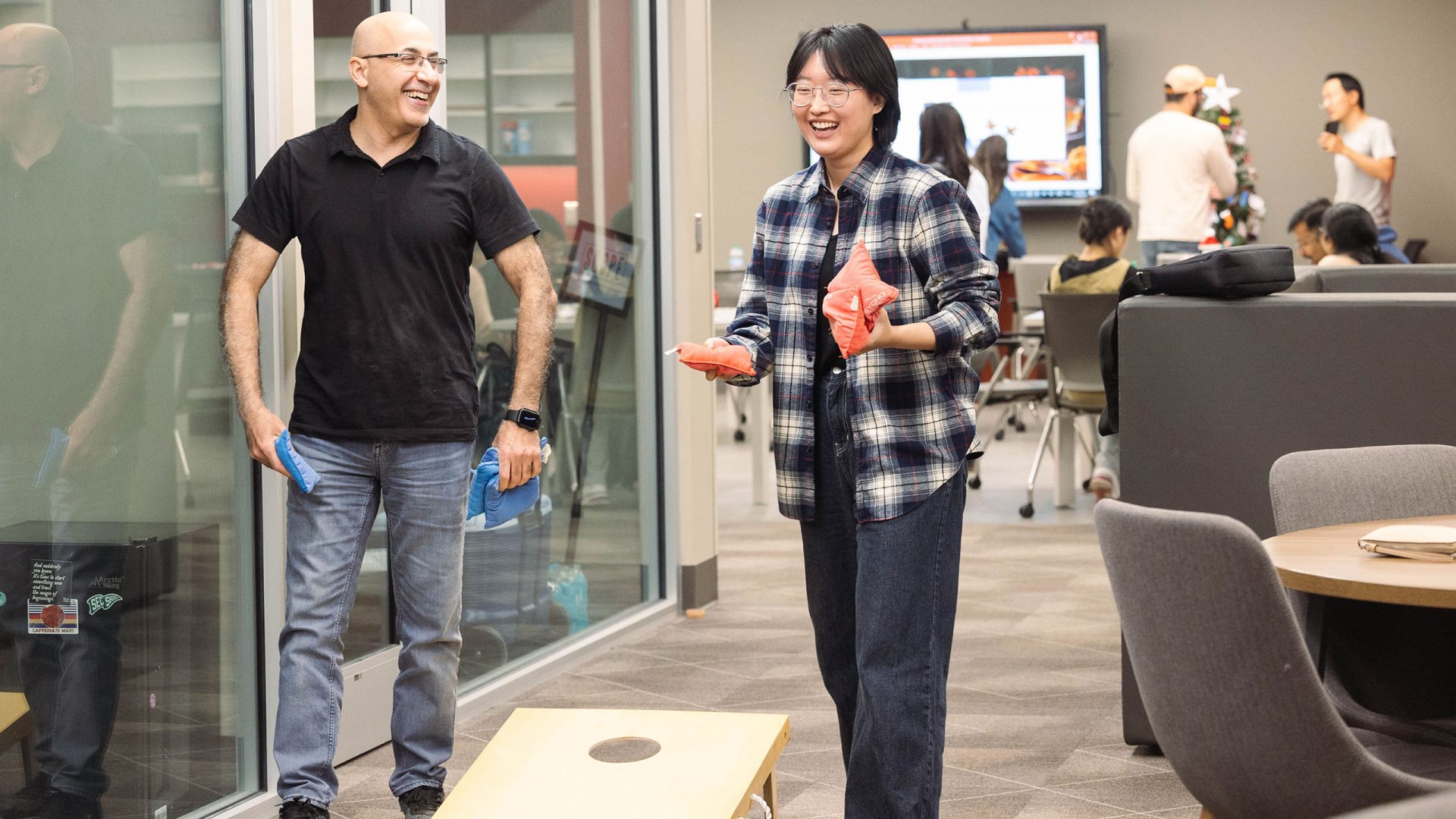 International visitors play corn hole at a Global Café event in the Student Community Engagement Center