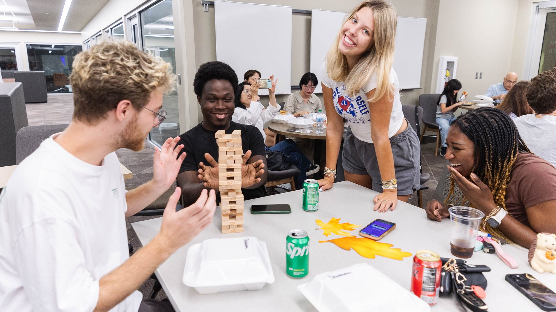 Students play Jenga at a Global Café event in the Student Community Engagement Center